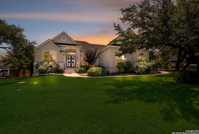 26130 Sunny Mdw, San Antonio, TX 78260 - view of front of property featuring stucco siding, a lawn, and french doors