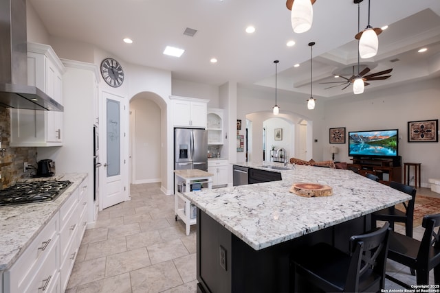 26130 Sunny Mdw, San Antonio, TX 78260 - kitchen featuring appliances with stainless steel finishes, wall chimney range hood, arched walkways, coffered ceiling, and a ceiling fan