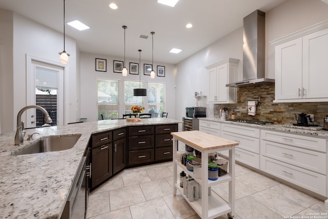 26130 Sunny Mdw, San Antonio, TX 78260 - kitchen with wall chimney exhaust hood, white cabinets, gas stovetop, tasteful backsplash, and dark brown cabinetry
