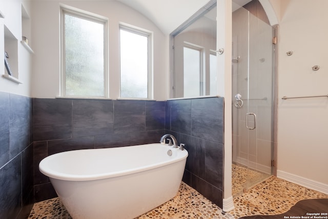26130 Sunny Mdw, San Antonio, TX 78260 - full bathroom with tile walls, a shower stall, a freestanding bath, and tile patterned floors
