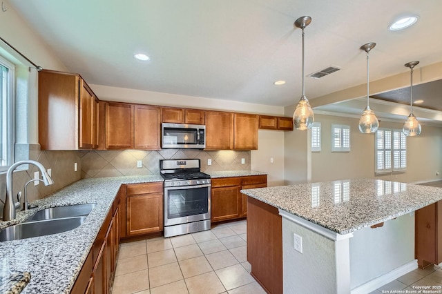 13059 Cache, San Antonio, TX 78253 - kitchen with appliances with stainless steel finishes, brown cabinets, backsplash, light tile patterned flooring, and light stone counters