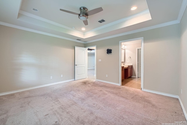 13059 Cache, San Antonio, TX 78253 - unfurnished bedroom featuring a tray ceiling, light colored carpet, crown molding, ensuite bath, and a walk in closet