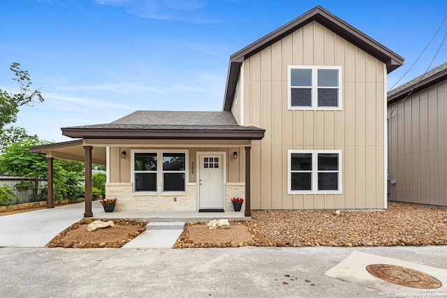 302 Riley Way, Kerrville, TX 78028 - view of front facade with a shingled roof, a porch, an attached carport, board and batten siding, and driveway