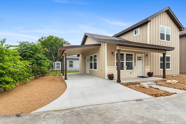 302 Riley Way, Kerrville, TX 78028 - view of front of home with concrete driveway, a porch, board and batten siding, and a carport