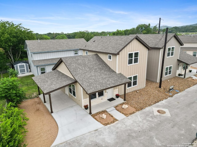 302 Riley Way, Kerrville, TX 78028 - view of side of home with roof with shingles, driveway, an attached carport, and covered porch