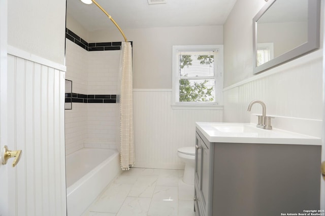 1002 Kampmann Blvd, San Antonio, TX 78201 - bathroom featuring wainscoting, marble finish flooring, vanity, and shower / tub combo with curtain