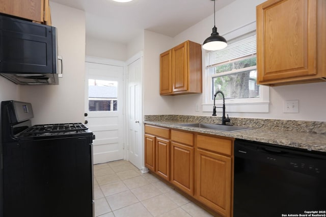 1002 Kampmann Blvd, San Antonio, TX 78201 - kitchen featuring black appliances, light tile patterned floors, decorative light fixtures, and brown cabinets