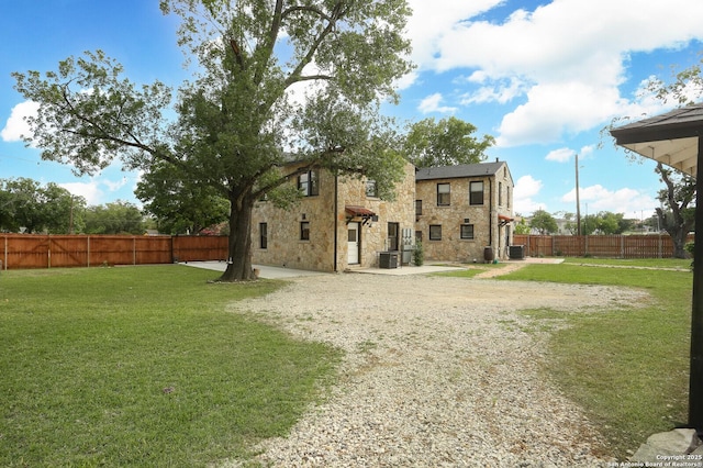 1002 Kampmann Blvd, San Antonio, TX 78201 - rear view of property featuring stone siding, a fenced backyard, and a patio area