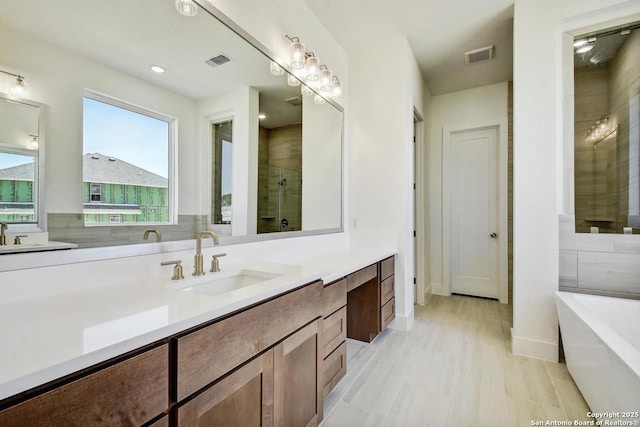 228 Dulce Vis, Boerne, TX 78006 - bathroom featuring a soaking tub, vanity, and a tile shower