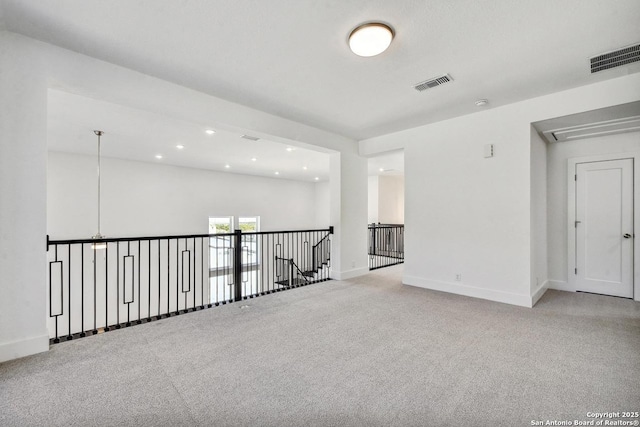 228 Dulce Vis, Boerne, TX 78006 - spare room featuring attic access, carpet floors, and recessed lighting