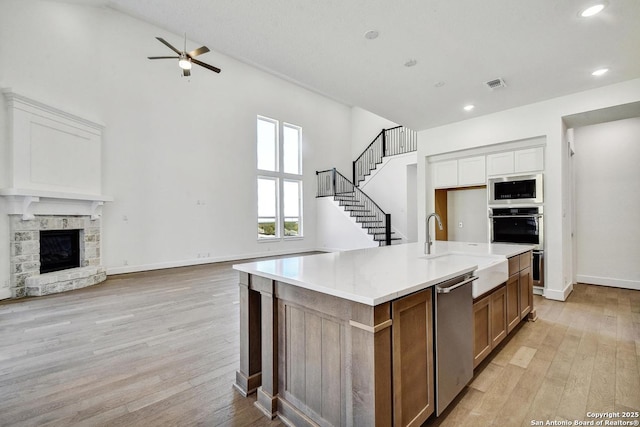 228 Dulce Vis, Boerne, TX 78006 - kitchen featuring stainless steel appliances, open floor plan, ceiling fan, light wood-type flooring, and high vaulted ceiling