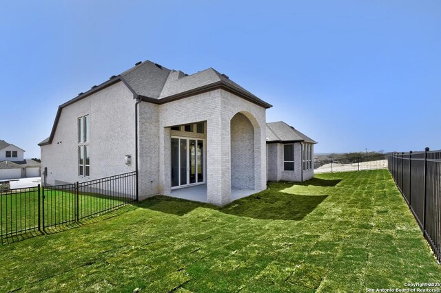 228 Dulce Vis, Boerne, TX 78006 - back of house with a fenced backyard, brick siding, and a patio area