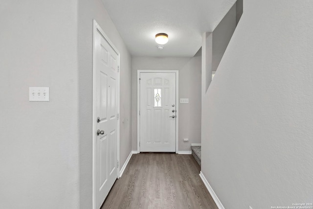 228 Blue Moon Gait, Selma, TX 78154 - doorway to outside featuring wood finished floors and baseboards