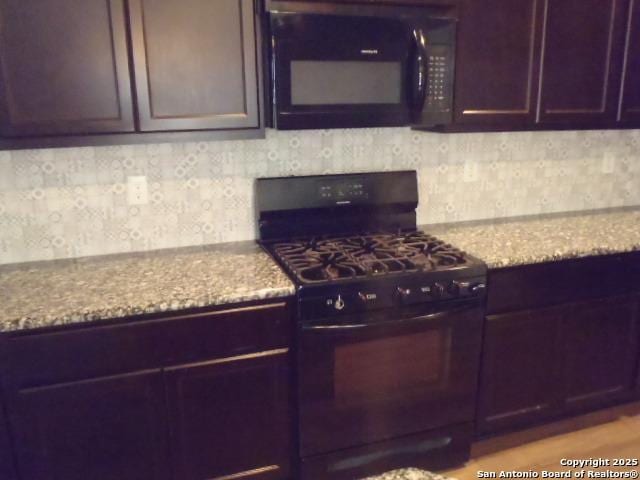 2690 Mccrae, New Braunfels, TX 78130 - kitchen featuring black appliances, tasteful backsplash, and light stone countertops