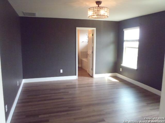 2690 Mccrae, New Braunfels, TX 78130 - spare room featuring wood finished floors and a chandelier