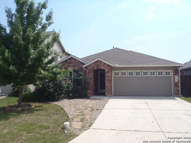 2690 Mccrae, New Braunfels, TX 78130 - view of front of house with concrete driveway, a garage, brick siding, and a front lawn