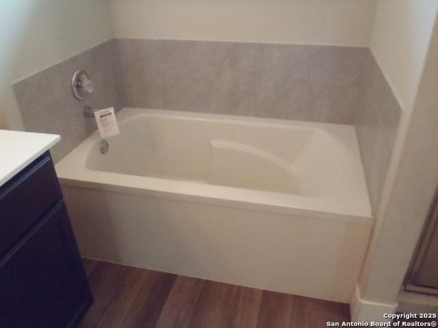 2690 Mccrae, New Braunfels, TX 78130 - full bathroom with a garden tub, vanity, and wood finished floors