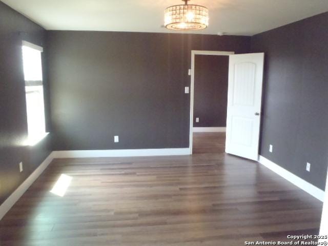 2690 Mccrae, New Braunfels, TX 78130 - unfurnished room featuring healthy amount of natural light, wood finished floors, and a chandelier