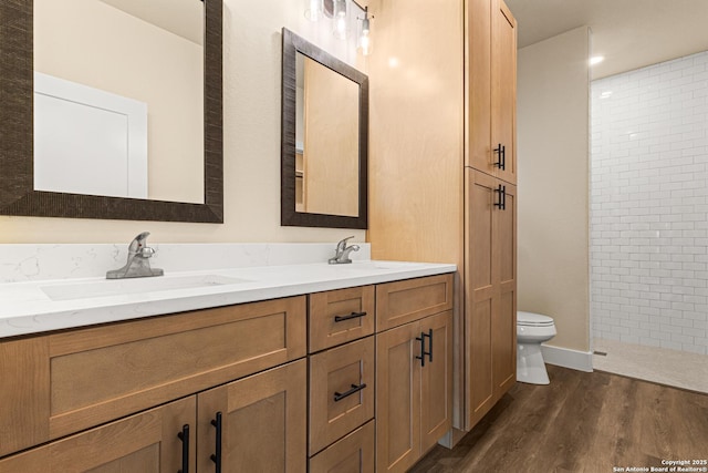 304 Riley Way, Kerrville, TX 78028 - full bathroom featuring double vanity, wood finished floors, and a tile shower
