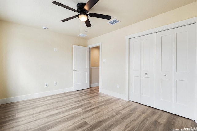304 Riley Way, Kerrville, TX 78028 - unfurnished bedroom with light wood finished floors, a closet, and a ceiling fan