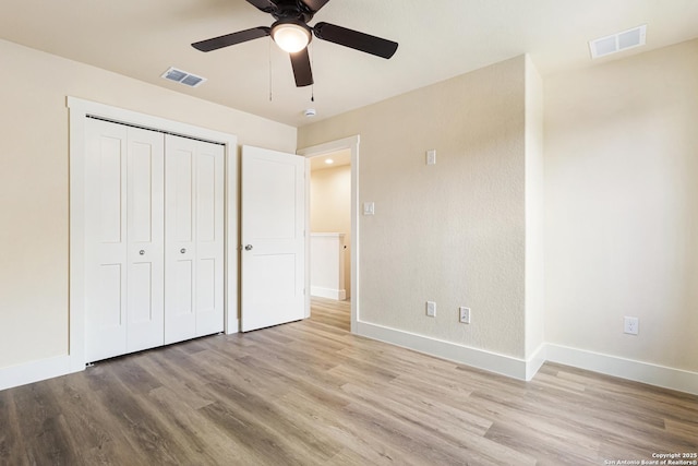 304 Riley Way, Kerrville, TX 78028 - unfurnished bedroom featuring wood finished floors, a closet, and ceiling fan