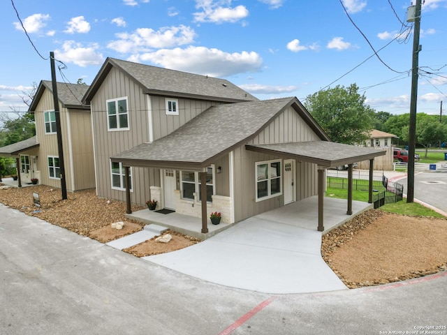 304 Riley Way, Kerrville, TX 78028 - view of front of home with roof with shingles, driveway, a porch, a carport, and board and batten siding