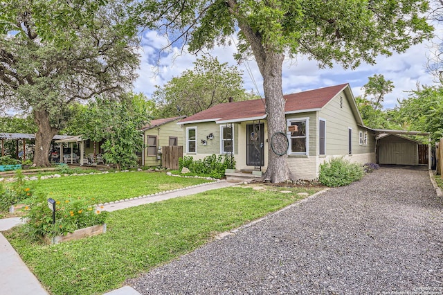 2122 W Hermosa, San Antonio, TX 78201 - view of front of home featuring gravel driveway, brick siding, and an attached carport