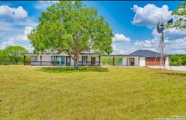 3250 Sandy Elm Ln, Vernia, TX 78121 - rear view of house with a yard, a carport, concrete driveway, covered porch, and a garage