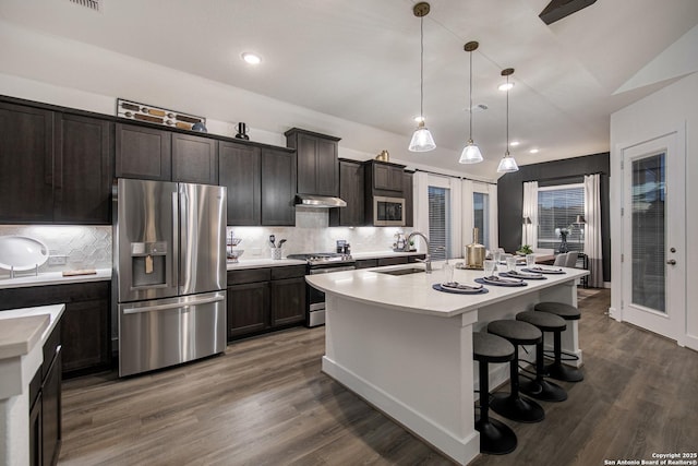 270 Lily Pass, Castroville, TX 78009 - kitchen featuring stainless steel appliances, under cabinet range hood, light countertops, backsplash, and recessed lighting