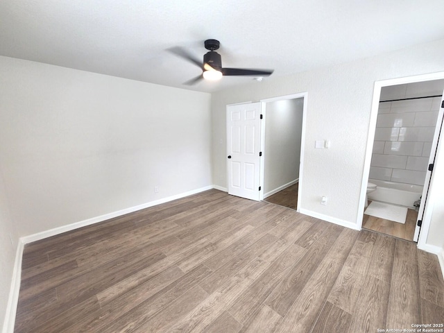 102 Wonder, San Antonio, TX 78213 - unfurnished bedroom featuring wood finished floors, ensuite bathroom, and a ceiling fan