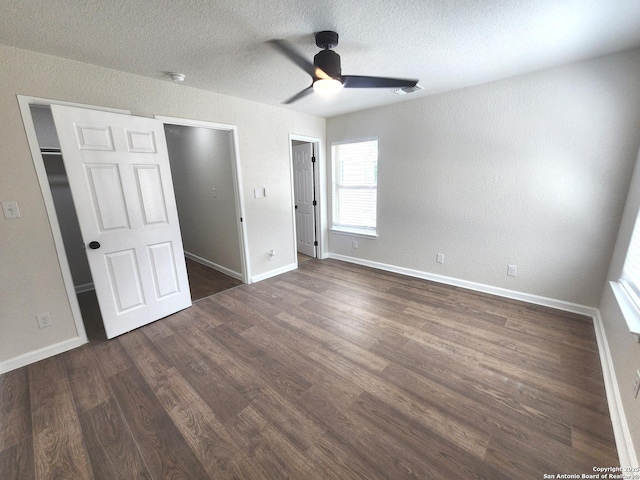 102 Wonder, San Antonio, TX 78213 - unfurnished bedroom featuring dark wood-type flooring, a textured ceiling, ceiling fan, and a textured wall