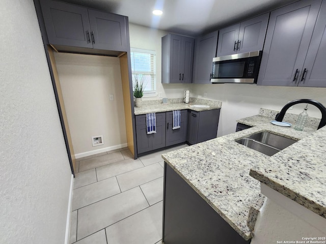 102 Wonder, San Antonio, TX 78213 - kitchen featuring stainless steel microwave, light stone countertops, and light tile patterned flooring