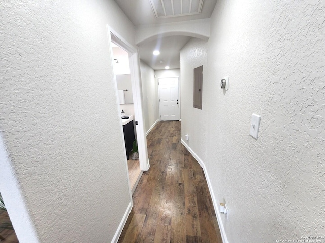 102 Wonder, San Antonio, TX 78213 - corridor with a textured wall, arched walkways, electric panel, and hardwood / wood-style floors