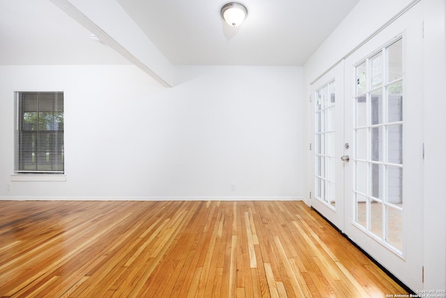 251 Serna, San Antonio, TX 78218 - empty room with light wood-type flooring, healthy amount of natural light, and french doors