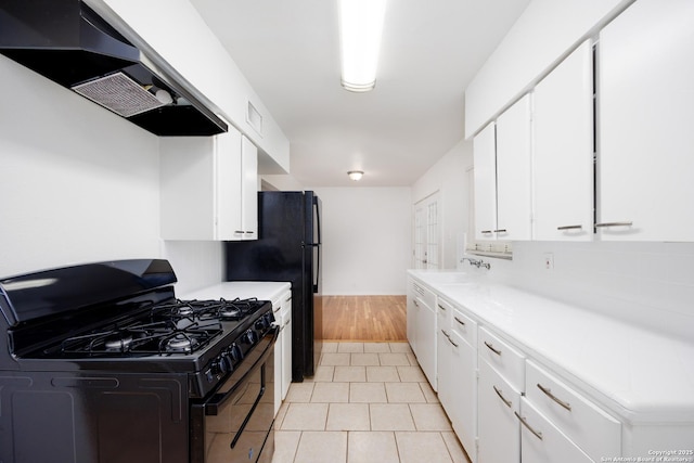 251 Serna, San Antonio, TX 78218 - kitchen with black appliances, range hood, white cabinets, and light countertops