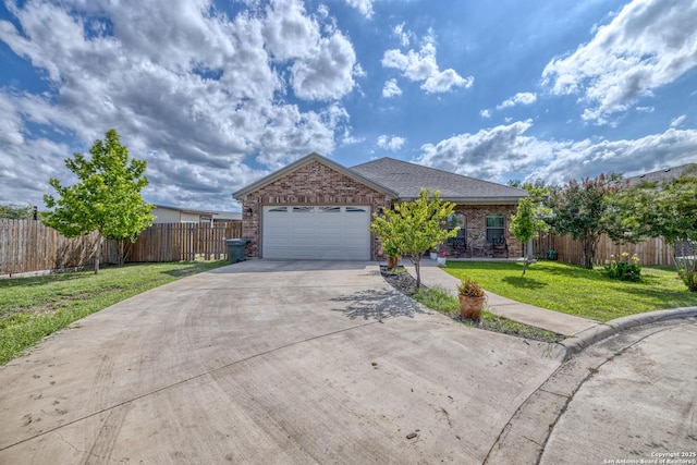 104 Sunday Ct, Uvalde, TX 78801 - ranch-style home featuring concrete driveway, brick siding, and a garage