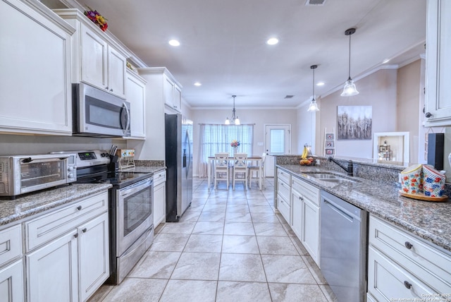 104 Sunday Ct, Uvalde, TX 78801 - kitchen featuring appliances with stainless steel finishes, ornamental molding, white cabinets, recessed lighting, and decorative light fixtures