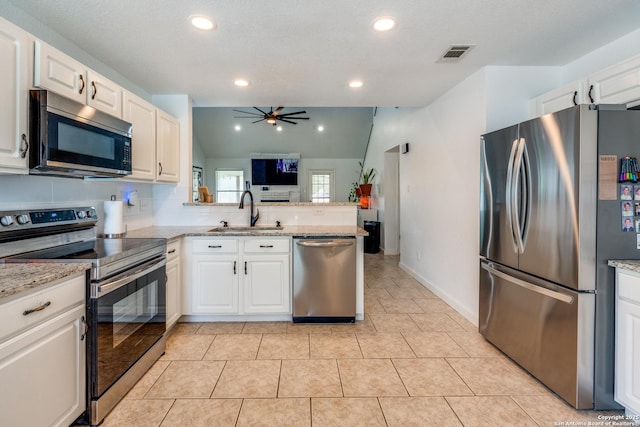 2500 Newning, Schertz, TX 78154 - kitchen with appliances with stainless steel finishes, a ceiling fan, white cabinetry, lofted ceiling, and recessed lighting