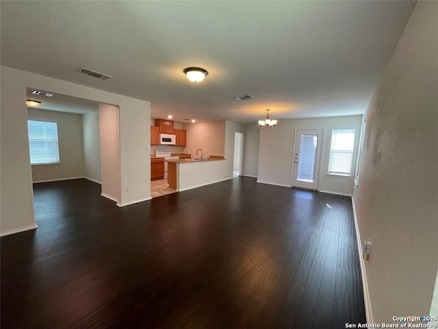 2092 Brandywine, New Braunfels, TX 78130 - unfurnished living room with a chandelier and dark wood-type flooring