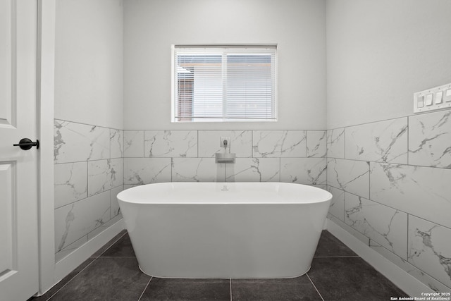 10706 Pharaoh Run, San Antonio, TX 78254 - full bathroom with tile walls, a soaking tub, a wainscoted wall, and tile patterned flooring