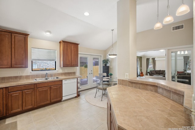 14630 Snip, San Antonio, TX 78248 - kitchen featuring dishwasher, french doors, tile counters, decorative light fixtures, and high vaulted ceiling
