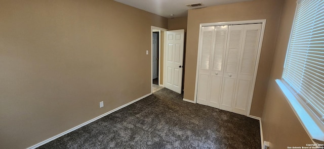 1826 Laven Dr, San Antonio, TX 78228 - unfurnished bedroom featuring dark colored carpet and a closet