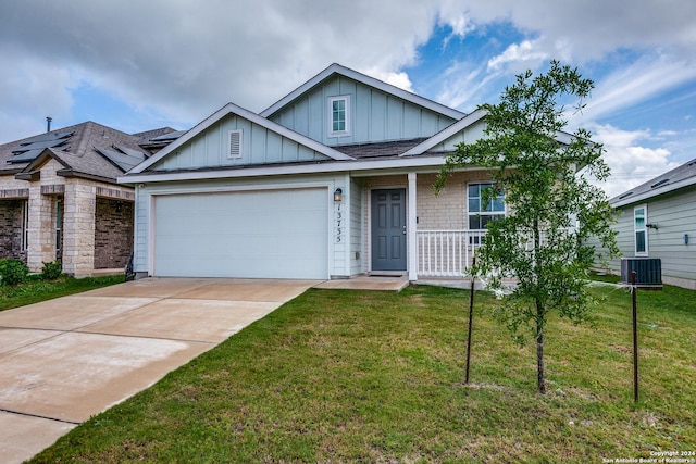 13735 Bradford Park, San Antonio, TX 78253 - view of front of home featuring board and batten siding, concrete driveway, a front lawn, and a garage