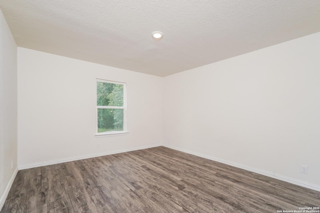 223 Baxter, Seguin, TX 78155 - empty room with wood finished floors and a textured ceiling