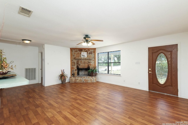 540 Soft Wind, Canyon Lake, TX 78133 - unfurnished living room with ceiling fan, wood finished floors, and a fireplace