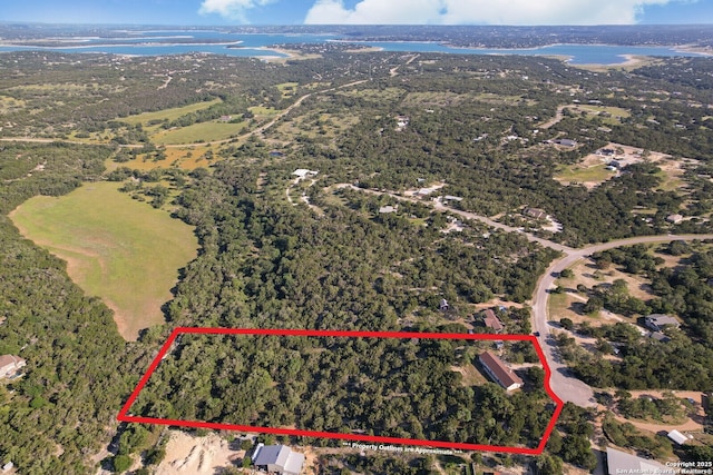 540 Soft Wind, Canyon Lake, TX 78133 - aerial view of property and surrounding area featuring property parcel outlined and a large body of water