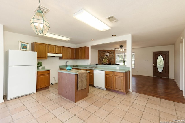 540 Soft Wind, Canyon Lake, TX 78133 - kitchen featuring white appliances, light countertops, under cabinet range hood, and light tile patterned floors
