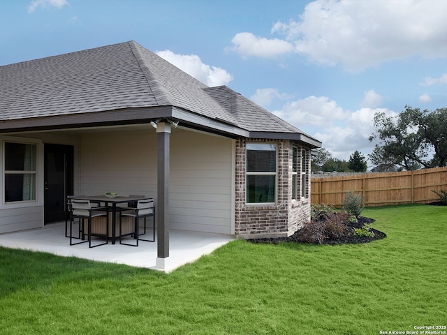 1124 Nikos Holw, San Antonio, TX 78245 - back of house with a patio area, a shingled roof, and brick siding