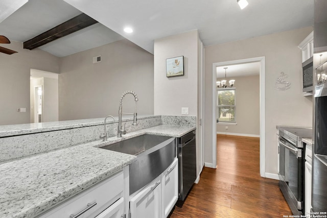 5811 Lake Chap, San Antonio, TX 78222 - kitchen with stainless steel appliances, light stone counters, dark wood-type flooring, white cabinets, and a chandelier