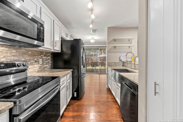 5811 Lake Chap, San Antonio, TX 78222 - kitchen with black appliances, decorative backsplash, white cabinets, and dark wood-type flooring